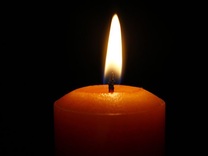 Candle closeup, black background
