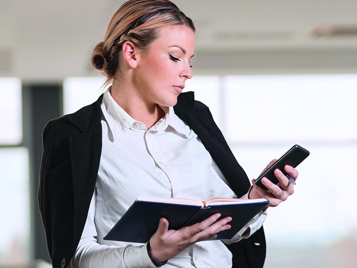 Modern business woman finishing a phone conversation with a colleague